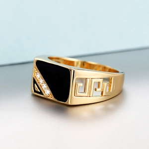 Detail of gold-plated ring featuring black enamel inlay and cubic zirconia stones