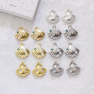 Detailed flat lay of gold and silver shell pendants with pearls for DIY jewelry making