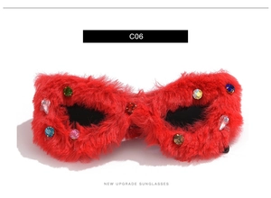 Detail of red faux fur cat eye sunglasses with colorful rhinestones and C06 model mark
