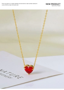 Detail of red heart zircon necklace with 18k gold plated titanium steel chain