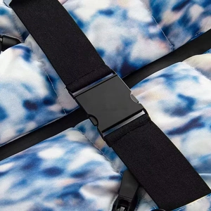 Macro detail of sky blue tie-dye puffer jacket with black buckle strap closure