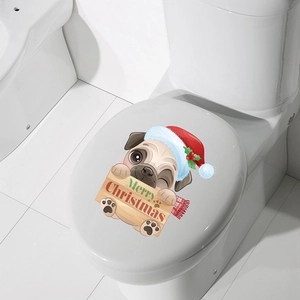 Close-up of a festive pug with Christmas hat and Merry Christmas sign on toilet lid
