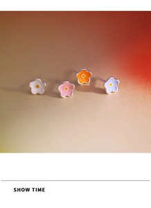 Macro shot of 925 silver needle flower stud earrings in white, pink, orange and purple