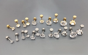 Detailed set of surgical steel screw-back stud earrings with round cubic zirconia stones