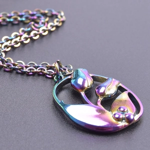 Macro shot of iridescent tulip flower pendant with vibrant colorful plating and ring chain