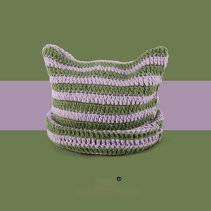 Close-up of purple and green striped knit cat ear hat with chunky wool texture