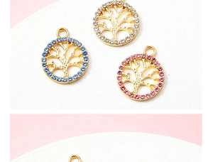 Detailed view of tree of life pendants in gold finish with blue, pink, and clear crystals