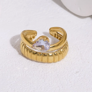 Detail of 18k gold plated ring with pear-cut zircon and unique textured double-layer band