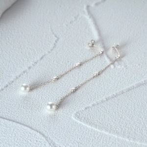 Macro view of S925 sterling silver tassel earrings with white pearls and tiny crystals