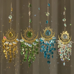 Detail of four sun and moon crystal suncatchers with vibrant rainbow light reflections