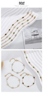 Detail of gold-plated stainless steel bracelet featuring square-cut emerald and zircons