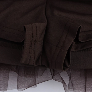Detailed close-up of dark brown knit fabric stitched with sheer mesh hem detailing