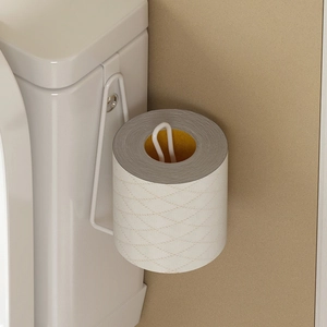 Detail of white metal over-tank toilet paper holder hook hanging on the tank