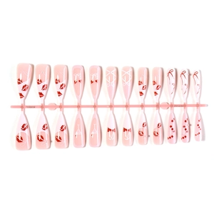 Pink press-on nail set with cherry red lips, bows, and pearls in long coffin shape