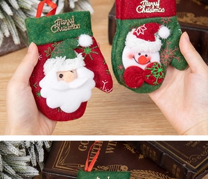Close-up of Merry Christmas embroidery on red and green felt mini glove ornaments