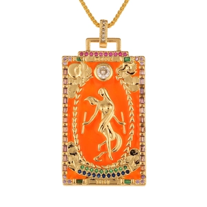 Detail of gold Tarot The World pendant featuring orange enamel and colorful zircons