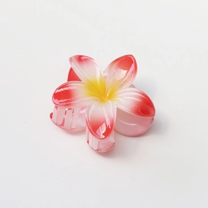 Close-up of 8cm plumeria hair claw clip with glossy resin finish and gradient petals