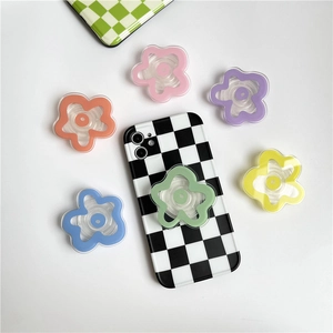 Detailed view of colorful flower phone grips on a checkered case with transparent base