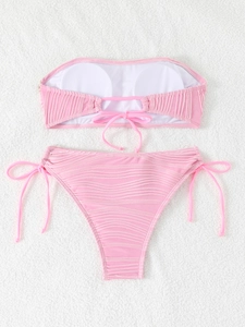 Detailed back view of pink bandeau bikini with textured fabric and tie closure