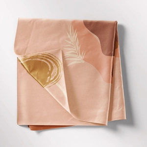 Detail shot of bohemian tapestry fabric texture with abstract palm leaf print and neat edge stitching
