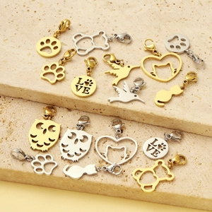 Golden and silver stainless steel animal pendants including paw, bear, and owl shapes