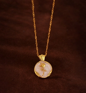 Detailed close-up of a vintage 925 silver rose pendant with gold finish and enamel inlay