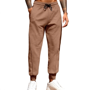 Men's trendy joggers in tan fabric featuring drawstring waist and ribbed ankle cuffs