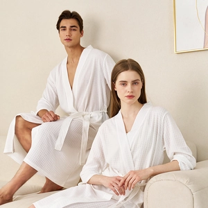 Matching couple's white waffle weave bathrobes with belted waist for summer comfort