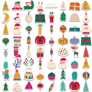Flat lay of Christmas stickers featuring Santa, reindeer, and snowmen on white background