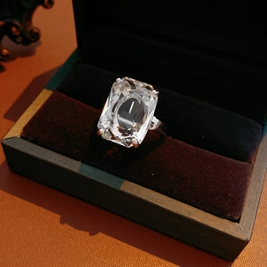 Macro detail of 14k gold plated square zircon ring set in a luxury black velvet jewelry box