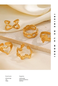 Detailed view of five vintage gold rings with heart and butterfly patterns on stone