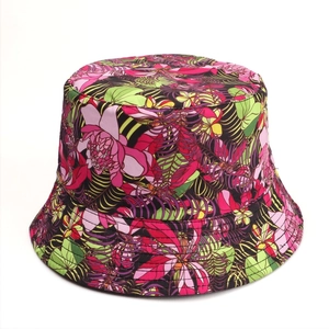 Close-up of double-sided bucket hat featuring vibrant tropical floral print on canvas fabric
