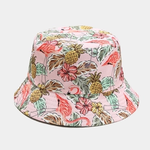 Close-up of pink bucket hat with tropical flamingo, pineapple and floral prints
