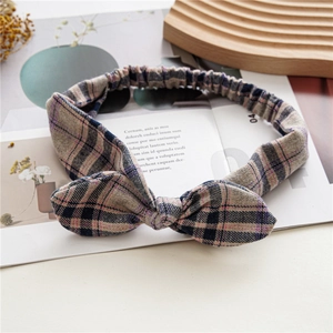 Detail of plaid bunny ear headband with elastic band on a lifestyle magazine background