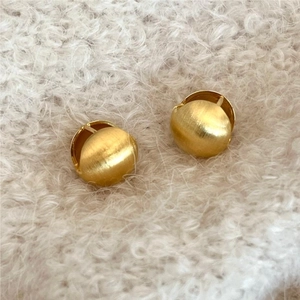 Brushed gold 925 sterling silver sphere earrings on soft white faux fur background