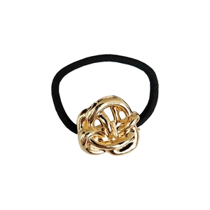 Close-up of a high-elastic black hair tie featuring a polished gold alloy metal knot detail