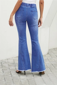 Close-up of high-waist elastic denim flare pants with distressed fringe hem in blue