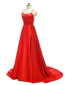 Detail of red satin evening gown showing the glossy fabric and thin shoulder straps