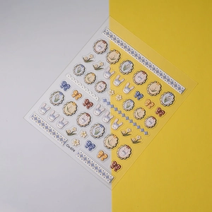 Macro detail of 3D embossed nail stickers featuring tulip, rabbit, and frame patterns