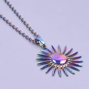 Macro shot of iridescent rainbow sun pendant on a stainless steel chain necklace