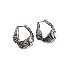 Modern twisted silver metal earrings with textured wire cage design and U-shaped geometry