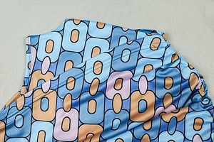 Close-up of geometric pattern print on fabric with blue and orange retro rectangle motifs