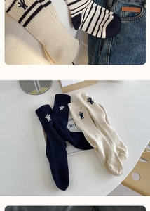 Detail of embroidered bear on cotton crew socks in cream white and navy blue colors