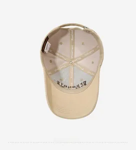 Detailed interior view of khaki baseball cap showing reinforced seams and fabric labels