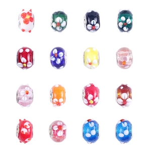 Detail of 16 colorful glass beads with white and yellow floral patterns for DIY jewelry