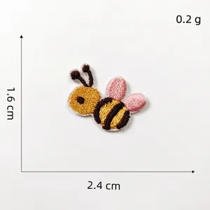 Close-up of small bee embroidery patch with size dimensions 1.6cm x 2.4cm and 0.2g weight