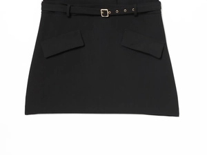 Detail of black mini skirt featuring a thin belt with a gold square buckle and twin pockets