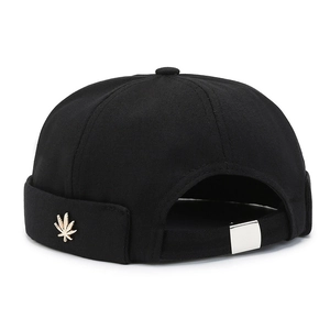 Black canvas docker hat with gold leaf emblem and adjustable strap in minimalist view