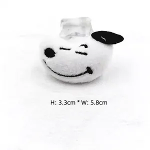 Detailed view of Snoopy-style plush badge with dimensions Height 3.3cm and Width 5.8cm