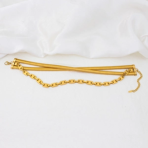 Minimalist multilayer gold layered snake and square box chain necklace on white silk
